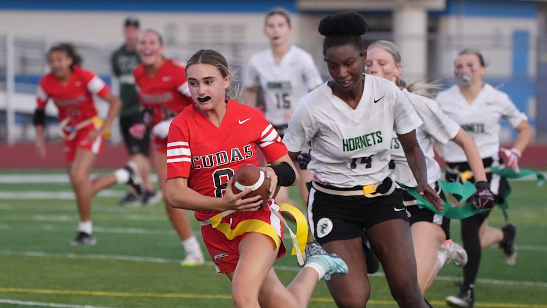 New Smyrna Beach's Molly Brock (8) eludes tacklers to run for a 43-yard touchdown against Weeki Wachee in a Class 2A, Region 2 quarterfinal game.