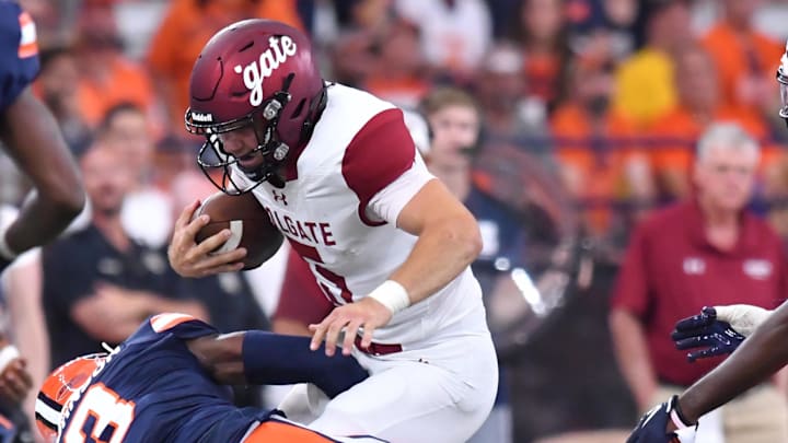 Sep 2, 2023; Syracuse, New York, USA; Colgate Raiders quarterback Michael Brescia (5) is tackled by Syracuse Orange cornerback Isaiah Johnson (3) in the second quarter at the JMA Wireless Dome. Mandatory Credit: Mark Konezny-Imagn Images