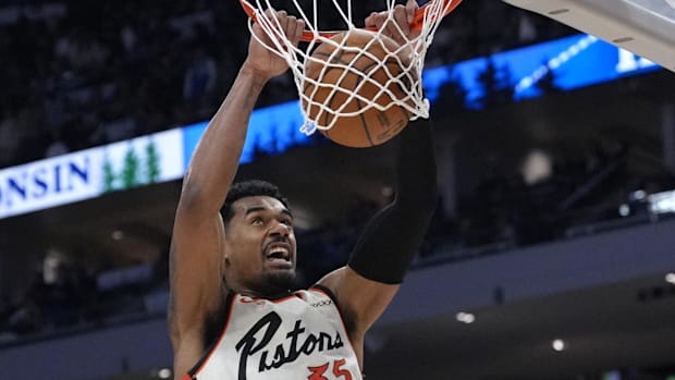 Detroit Pistons forward Tolu Smith (35) dunks the ball against Milwaukee Bucks guard Pat Connaughton (24)