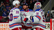 Mar 12, 2024; Raleigh, North Carolina, USA; New York Rangers goaltender Igor Shesterkin (31) goaltender Jonathan Quick (32) and left wing Chris Kreider (20) celebrate their victory against the Carolina Hurricanes at PNC Arena. Mandatory Credit: James Guillory-Imagn Images