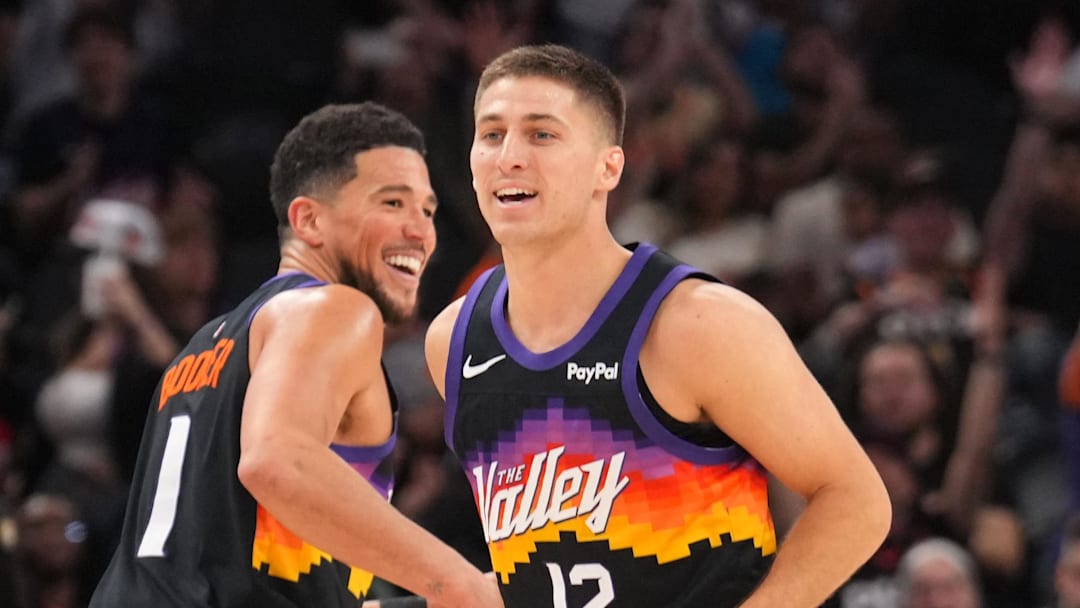 Mar 8, 2026; Phoenix, Arizona, USA; Phoenix Suns guard Devin Booker (1) and Phoenix Suns guard Collin Gillespie (12) react against the Charlotte Hornets during the second half at Mortgage Matchup Center. Mandatory Credit: Joe Camporeale-Imagn Images