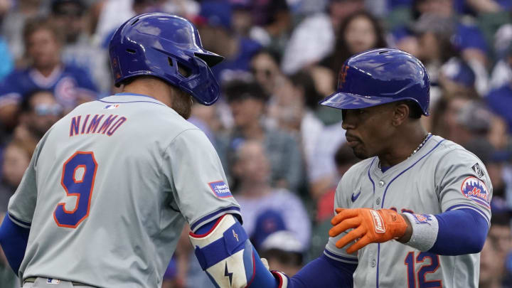 Jun 23, 2024; Chicago, Illinois, USA; New York Mets shortstop Francisco Lindor (12) is greeted by outfielder Brandon Nimmo (9) after hitting a two-run home run against the Chicago Cubs during the third inning at Wrigley Field. Mandatory Credit: David Banks-USA TODAY Sports