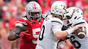 Aug 31, 2024; Columbus, OH, USA; Ohio State Buckeyes defensive tackle Ty Hamilton (58) pursues Akron Zips quarterback Ben Finley (10) during the NCAA football game at Ohio Stadium. Ohio State won 52-6.