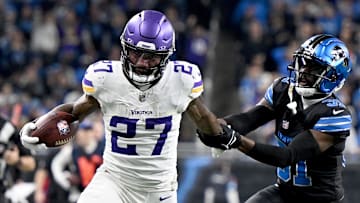 Jan 5, 2025; Detroit, Michigan, USA; Minnesota Vikings running back Cam Akers (27) tries to keep Detroit Lions safety Kerby Joseph (31) at bay as he runs up the sidelines in the third quarter at Ford Field.