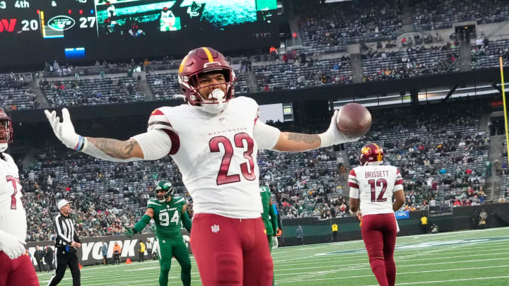 Dec 24, 2023; East Rutherford, New Jersey, USA;  Washington Commanders running back Chris Rodriguez Jr. (23) celebrates a second half touchdown against the New York Jets at MetLife Stadium. Mandatory Credit: Robert Deutsch-USA TODAY Sports