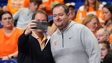 A Tennessee fan takes a photos with Tennessee football coach Josh Heupel at the NCAA Tournament Elite Eight game between Tennessee and Houston at Lucas Oil Stadium in Indianapolis, Ind., on Sunday, March 30, 2025.