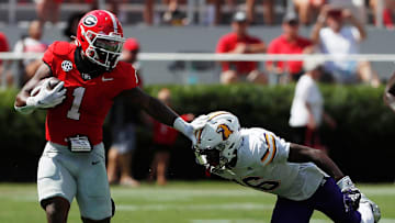 Georgia running back Trevor Etienne (1) stiff-arms Tennessee Tech defensive back Omari Philyaw (16) during the first half of a NCAA college football game in Athens, Ga., on Saturday, Sept. 7, 2024.