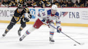 Oct 9, 2024; Pittsburgh, Pennsylvania, USA;  New York Rangers right wing Kaapo Kakko (24) skates up ice on a breakaway as Pittsburgh Penguins defenseman Kris Letang (58) chases during the second period at PPG Paints Arena. Mandatory Credit: Charles LeClaire-Imagn Images