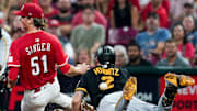 Cincinnati Reds pitcher Brady Singer (51) drops the ball on a tag out on Pittsburgh Pirates first baseman Spencer Horwitz (2) in the fifth inning of a MLB game between the Cincinnati Reds and Pittsburgh Pirates, Tuesday, Sept. 23, 2025, at Great American Ball Park in downtown Cincinnati.