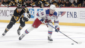 Oct 9, 2024; Pittsburgh, Pennsylvania, USA;  New York Rangers right wing Kaapo Kakko (24) skates up ice on a breakaway as Pittsburgh Penguins defenseman Kris Letang (58) chases during the second period at PPG Paints Arena. Mandatory Credit: Charles LeClaire-Imagn Images