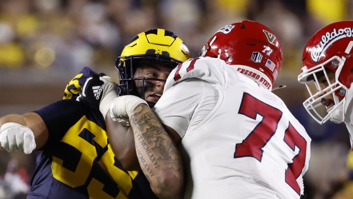 Aug 31, 2024; Ann Arbor, Michigan, USA;  Fresno State Bulldogs offensive lineman Toreon Penright (77) blocks Michigan Wolverines defensive lineman Mason Graham (55) in the second half at Michigan Stadium. Mandatory Credit: Rick Osentoski-USA TODAY Sports