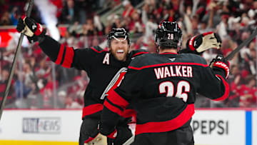 May 12, 2025; Raleigh, North Carolina, USA; Carolina Hurricanes defenseman Sean Walker (26) is congratulated by defenseman Jaccob Slavin (74) after his goal against the Washington Capitals during the third period in game four of the second round of the 2025 Stanley Cup Playoffs at Lenovo Center. Mandatory Credit: James Guillory-Imagn Images