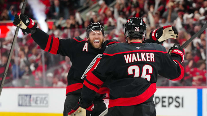 May 12, 2025; Raleigh, North Carolina, USA; Carolina Hurricanes defenseman Sean Walker (26) is congratulated by defenseman Jaccob Slavin (74) after his goal against the Washington Capitals during the third period in game four of the second round of the 2025 Stanley Cup Playoffs at Lenovo Center. Mandatory Credit: James Guillory-Imagn Images
