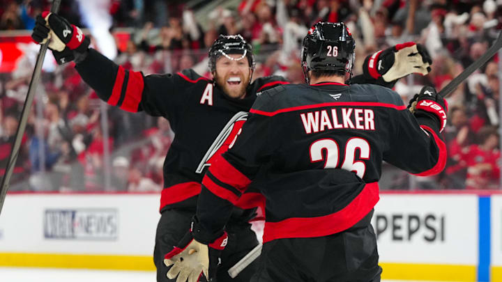 May 12, 2025; Raleigh, North Carolina, USA; Carolina Hurricanes defenseman Sean Walker (26) is congratulated by defenseman Jaccob Slavin (74) after his goal against the Washington Capitals during the third period in game four of the second round of the 2025 Stanley Cup Playoffs at Lenovo Center. Mandatory Credit: James Guillory-Imagn Images