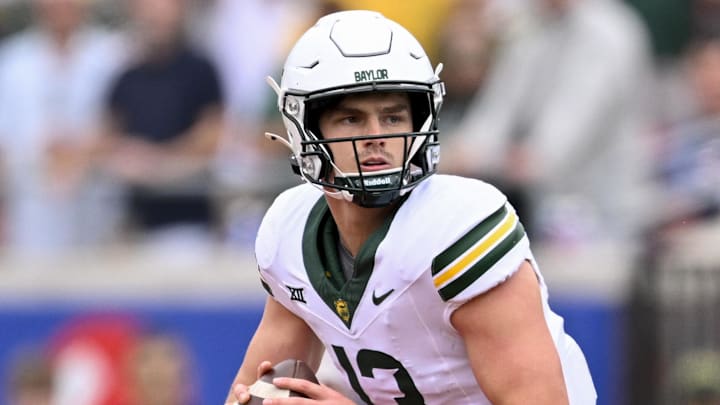 Sep 6, 2025; Dallas, Texas, USA; Baylor Bears quarterback Sawyer Robertson (13) rolls out with the ball during the game between the SMU Mustangs and the Baylor Bears at Gerald J. Ford Stadium. Mandatory Credit: Jerome Miron-Imagn Images