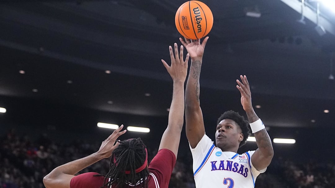 Mar 20, 2025; Providence, RI, USA;  Kansas Jayhawks guard AJ Storr (2) shoots the ball against Arkansas Razorbacks forward Jonas Aidoo (9) during the second half at Amica Mutual Pavilion. Mandatory Credit: Gregory Fisher-Imagn Images