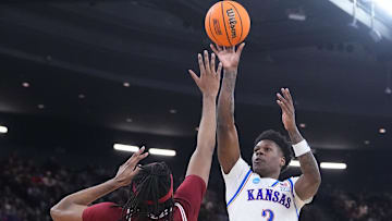 Mar 20, 2025; Providence, RI, USA;  Kansas Jayhawks guard AJ Storr (2) shoots the ball against Arkansas Razorbacks forward Jonas Aidoo (9) during the second half at Amica Mutual Pavilion. Mandatory Credit: Gregory Fisher-Imagn Images