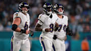 Oct 30, 2025; Miami Gardens, Florida, USA; Baltimore Ravens quarterback Lamar Jackson (8) runs up to the line with center Tyler Linderbaum (64) and offensive tackle Roger Rosengarten (70) during the third quarter against the Miami Dolphins at Hard Rock Stadium.