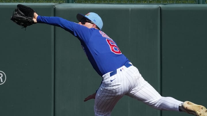 Feb 25, 2026; Mesa, Arizona, USA; Chicago Cubs third baseman Matt Shaw (6) drops the ball against the Colorado Rockies in the first inning at Sloan Park. Mandatory Credit: Rick Scuteri-Imagn Images