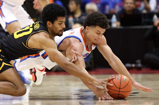 Wichita State guard Harlond Beverly and Florida guard Walter Clayton Jr. fight for a loose ball.