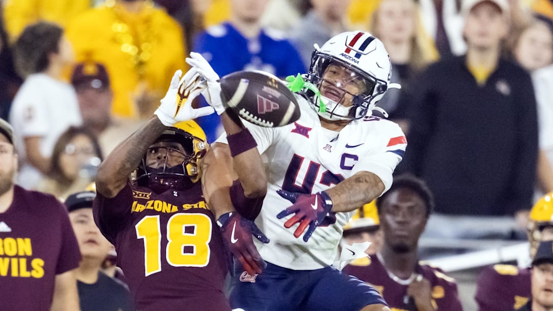 Nov 28, 2025; Tempe, Arizona, USA; Arizona Wildcats defensive back Dalton Johnson (43) breaks up a pass to Arizona State Sun Devils wide receiver Jalen Moss (18) in the second half during the 99th Territorial Cup at Mountain America Stadium. Mandatory Credit: Mark J. Rebilas-Imagn Images