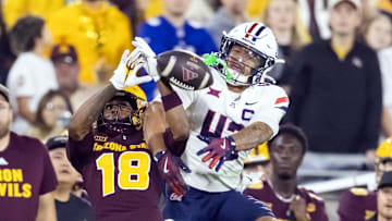 Nov 28, 2025; Tempe, Arizona, USA; Arizona Wildcats defensive back Dalton Johnson (43) breaks up a pass to Arizona State Sun Devils wide receiver Jalen Moss (18) in the second half during the 99th Territorial Cup at Mountain America Stadium. Mandatory Credit: Mark J. Rebilas-Imagn Images