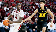 Former Arkansas guard Davonte Davis drives against Missouri forwardTrevon Brazile.