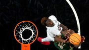 San Francisco Dons forward Jonathan Mogbo (10) rises for a shot as Cincinnati Bearcats forward Aziz Bandaogo (55) defends in the first half of a college basketball game in the National Invitation Tournament, Wednesday, March 20, 2024, at Fifth Third Arena in Cincinnati.