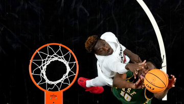 San Francisco Dons forward Jonathan Mogbo (10) rises for a shot as Cincinnati Bearcats forward Aziz Bandaogo (55) defends in the first half of a college basketball game in the National Invitation Tournament, Wednesday, March 20, 2024, at Fifth Third Arena in Cincinnati.