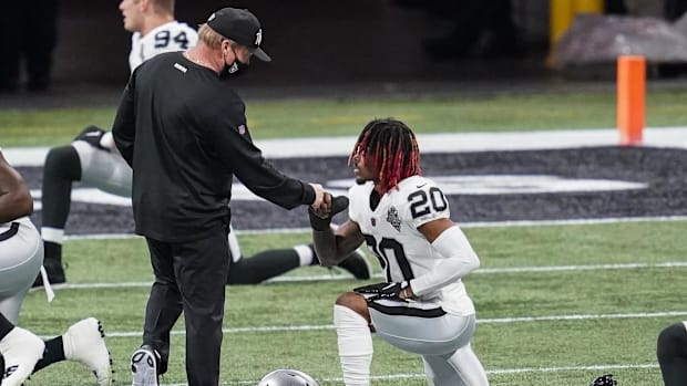 Las Vegas Raiders head coach John Gruden reacts with cornerback Damon Arnette