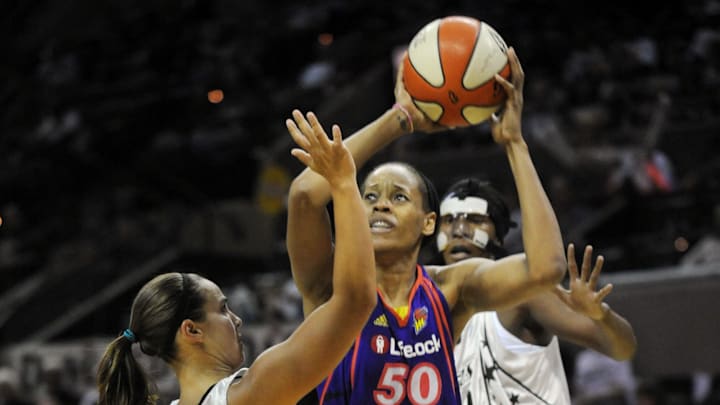 August 28, 2010; San Antonio, TX, USA; Phoenix Mercury center Tangela Smith (50) controls the ball under pressure from San Antonio Silver Stars guard Becky Hammon (25) and forward Crystal Kelly (behind) during the second half at the AT&T Center. Phoenix beat San Antonio 92-73. Mandatory Credit: Brendan Maloney-Imagn Images