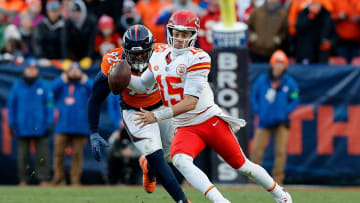 Oct 29, 2023; Denver, Colorado, USA; Kansas City Chiefs quarterback Patrick Mahomes (15) scrambles ahead of Denver Broncos defensive tackle Jonathan Harris (92) in the fourth quarter at Empower Field at Mile High. Mandatory Credit: Isaiah J. Downing-USA TODAY Sports