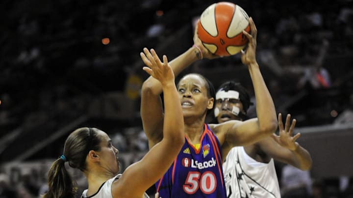 August 28, 2010; San Antonio, TX, USA; Phoenix Mercury center Tangela Smith (50) controls the ball under pressure from San Antonio Silver Stars guard Becky Hammon (25) and forward Crystal Kelly (behind) during the second half at the AT&T Center. Phoenix beat San Antonio 92-73. Mandatory Credit: Brendan Maloney-Imagn Images