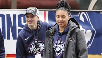UConn stars Paige Bueckers and Azzi Fudd walk celebrate the national championship at the Huskies' victory parade. 