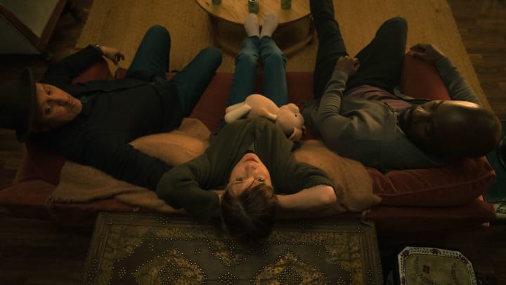 Ben (Aasif Mandvi), Kristen (Katja Herbers), and David (Mike Colter) sit together on a couch