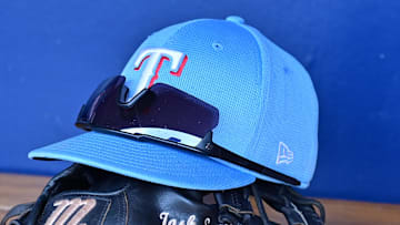 Mar 15, 2024; Salt River Pima-Maricopa, Arizona, USA; General view of a Texas Rangers hat, glove, and glasses prior to a spring training game against the Colorado Rockies at Salt River Fields at Talking Stick. 
