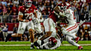 Oklahoma defensive back Reggie Powers III and linebacker Kobie McKinzie combine to make a tackle against Alabama. 