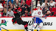 Mar 28, 2025; Raleigh, North Carolina, USA;  Montreal Canadiens defenseman Kaiden Guhle (21) checks against the Carolina Hurricanes during the third period at Lenovo Center. Mandatory Credit: James Guillory-Imagn Images