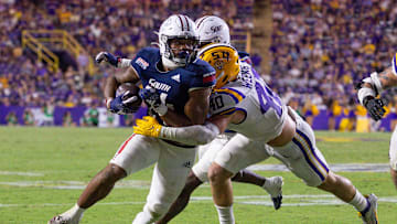 Sep 28, 2024; Baton Rouge, Louisiana, USA;  South Alabama Jaguars running back Fluff Bothwell (24) is tackled by LSU Tigers linebacker Whit Weeks (40) during the second half at Tiger Stadium. Mandatory Credit: Stephen Lew-Imagn Images