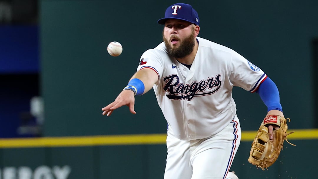 April 23, 2026; Arlington, Texas, USA; Texas Rangers first baseman Jake Burger (21) makes a throw to first base during the eighth inning against the Pittsburgh Pirates at Globe Life Field. Mandatory Credit: Kevin Jairaj-Imagn Images
