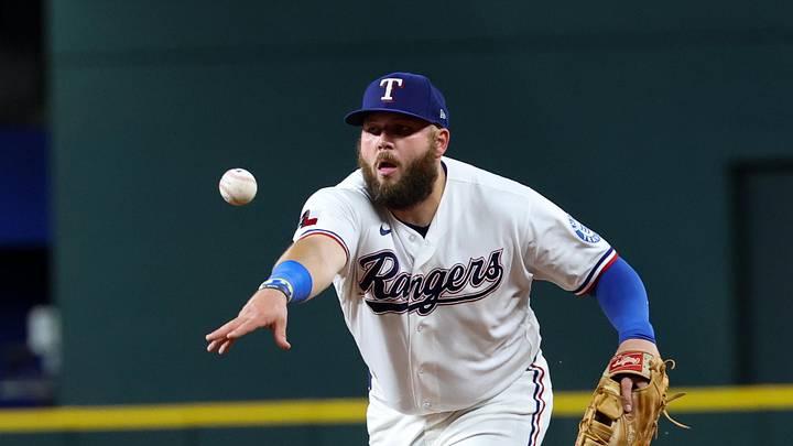 April 23, 2026; Arlington, Texas, USA; Texas Rangers first baseman Jake Burger (21) makes a throw to first base during the eighth inning against the Pittsburgh Pirates at Globe Life Field. Mandatory Credit: Kevin Jairaj-Imagn Images