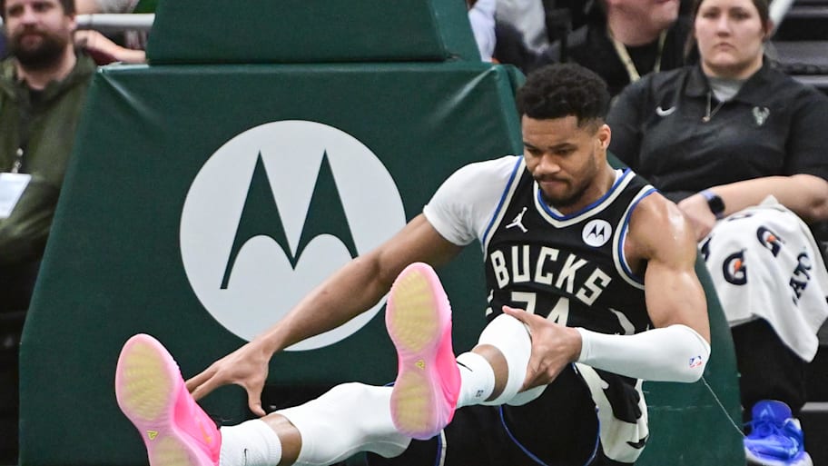 Milwaukee Bucks forward Giannis Antetokounmpo holds his knee after dunking a basket against the Indiana Pacers.