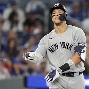 Oct 5, 2025; Toronto, Ontario, CAN; New York Yankees right fielder Aaron Judge (99) reacts after a walk in the ninth inning against the Toronto Blue Jays during game two of the ALDS round for the 2025 MLB playoffs at Rogers Centre. Mandatory Credit: John E. Sokolowski-Imagn Images
