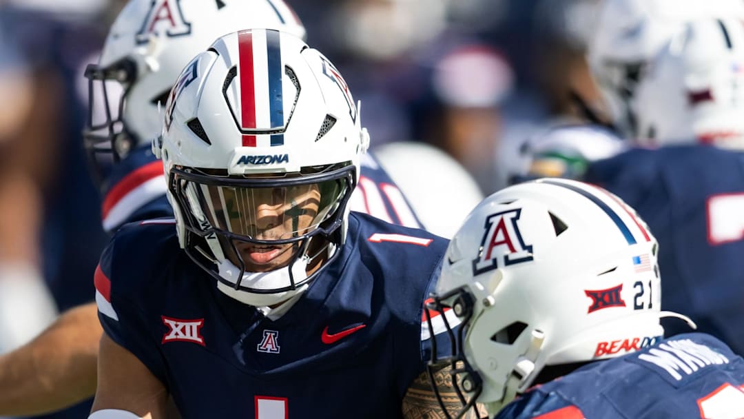 Nov 22, 2025; Tucson, Arizona, USA; Arizona Wildcats quarterback Noah Fifita (1) hands off the ball to running back Ismail Mahdi (21) against the Baylor Bears at Casino Del Sol Stadium. Mandatory Credit: Mark J. Rebilas-Imagn Images