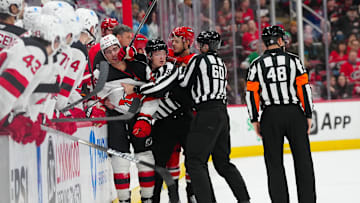 Dec 28, 2024; Raleigh, North Carolina, USA;  Carolina Hurricanes center Jesperi Kotkaniemi (82) fights New Jersey Devils right wing Timo Meier (28) after his hit on 
 center Martin Necas (88) (not shown) during the third period at Lenovo Center. Mandatory Credit: James Guillory-Imagn Images