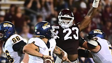 Sep 14, 2024; Starkville, Mississippi, USA; Mississippi State Bulldogs defensive lineman Trevion Williams (23) defends Toledo Rockets quarterback Tucker Gleason (4) during the second quarter at Davis Wade Stadium at Scott Field. Mandatory Credit: Matt Bush-Imagn Images