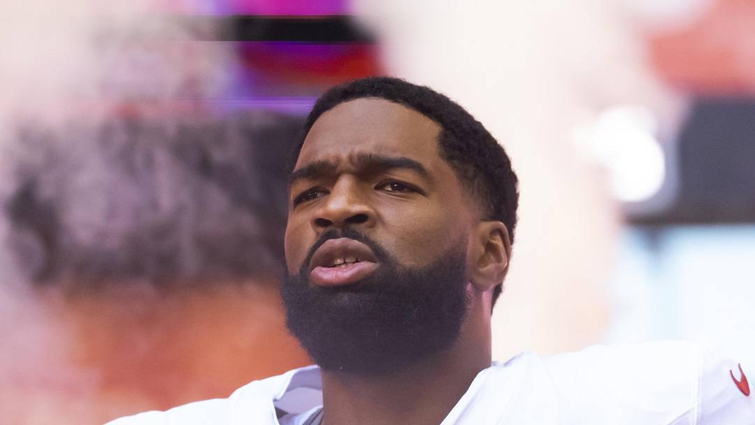 Arizona Cardinals quarterback Jacoby Brissett runs onto the field