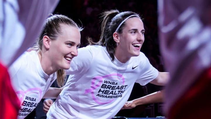 Indiana Fever guard Kristy Wallace (3) and Indiana Fever guard Caitlin Clark (22) smile in a huddle Friday, Aug. 16, 2024, before the game at Gainbridge Fieldhouse in Indianapolis.