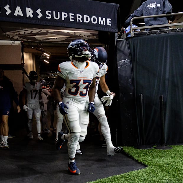 Denver Broncos running back Javonte Williams runs out of the tunnel before a game against the New Orleans Saints 