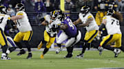 Jan 11, 2025; Baltimore, Maryland, USA; Pittsburgh Steelers quarterback Russell Wilson (3) runs against Baltimore Ravens defensive tackle Travis Jones (98) in the first quarter in an AFC wild card game at M&T Bank Stadium. Mandatory Credit: Geoff Burke-Imagn Images